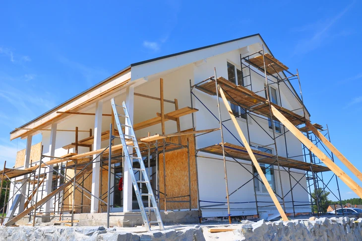 Extension d'une maison de famille, de forme cubique moderne avec un toit plat et de grandes fenêtres et une terrasse